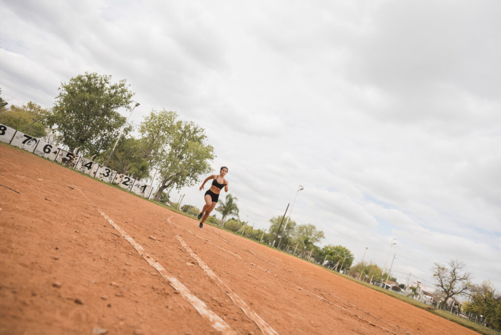 sporty woman running stadium track